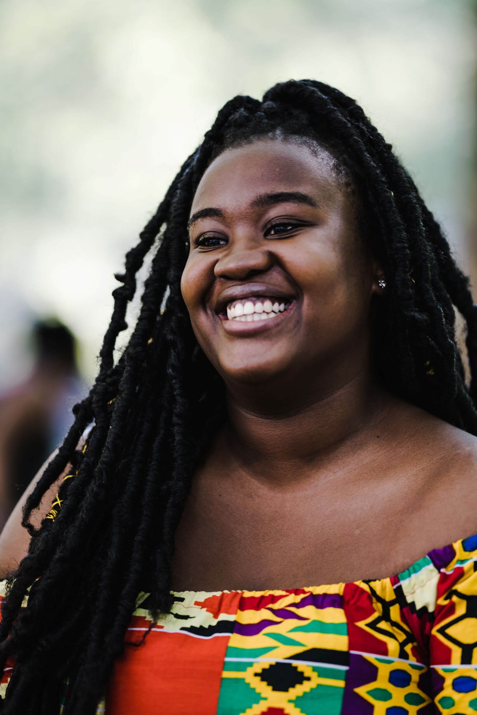 black woman with braids smiling